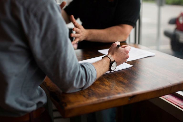 Two people discussing business over a table