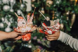 people holding ice cream concoctions